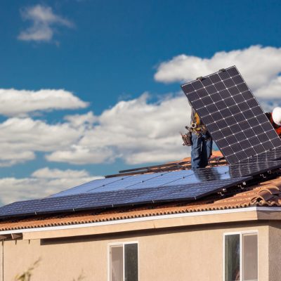 Workers Installing Solar Panels on House Roof. Workers Installing Solar Panels on House Roof.